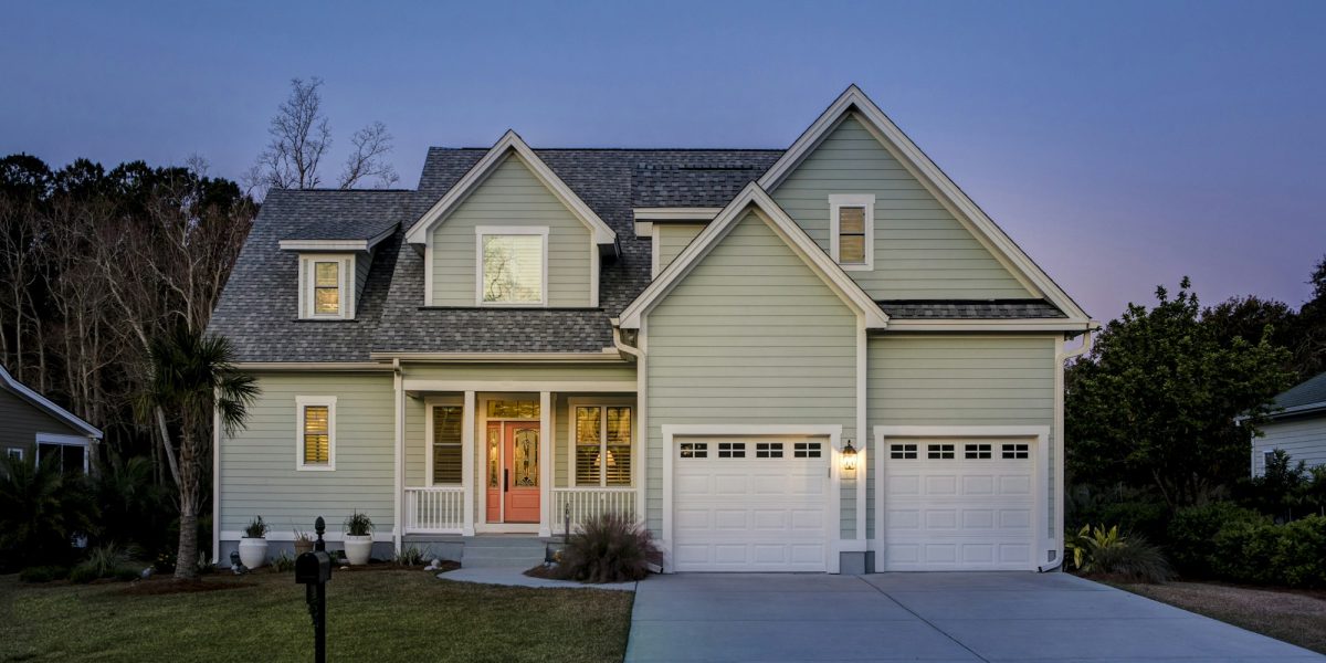 Front elevation of beautiful home lit up at twilight. Front elevation of beautiful home lit up at twilight.